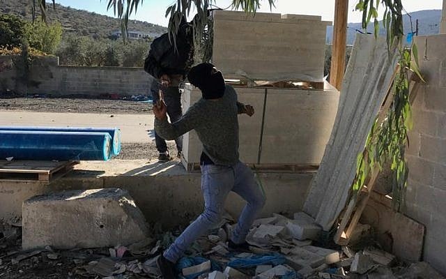 Palestinians in West Bank village of Hawara clash with IDF forces on December 8, 2017, during riots over US President Donald Trump's recognition of Jerusalem as Israel's capital on December 8, 2017.  (Jacob Magid/Times of Israel)
