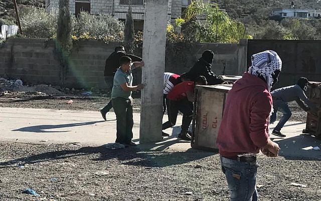 Palestinians in West Bank village of Hawara clash with IDF forces on December 8, 2017, during riots over US President Donald Trump's recognition of Jerusalem as Israel's capital on December 8, 2017. (Jacob Magid/Times of Israel) Palestinians in West Bank village of Hawara clash with IDF forces on December 8, 2017, during riots over US President Donald Trump's recognition of Jerusalem as Israel's capital on December 8, 2017. (Jacob Magid/Times of Israel)