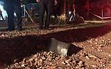 Police officers locate a rocket that was fired from the Gaza Strip and struck southern Israel on December 17, 2017. (Israel Police)