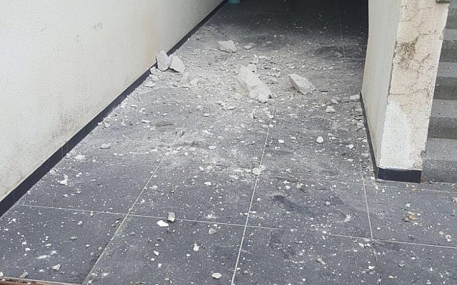 The damage cause by a mortar shell fired from the Gaza Strip that landed at the entrance to a building in the Shaar Hanegev region, December 29, 2017. (Israel Police) The damage cause by a mortar shell fired from the Gaza Strip that landed at the entrance to a building in the Shaar Hanegev region, December 29, 2017. (Israel Police)