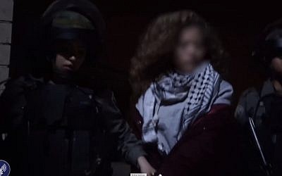 Israeli security forces arrest Ahed Tamimi for hitting soldiers in the West Bank city of Nabi Saleh on December 19, 2017. (screen capture: Israel Defense Forces)
