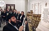 Chabad Rabbi Shalom Dov Ber Stambler lights the hannukah candles in Polish Parliament on December 12, 2017. (Screen capture/Facebook)