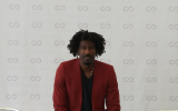 Amar’e Stoudemire at SCOPE Miami, where a painting he commissioned on the destruction of the Second Temple is exhibited. (Patrice Worthy/Times of Israel)