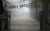 The main gate of the former Auschwitz extermination camp in Oswiecim, Poland, with the infamous sign reading 'Work sets you free.' (Christopher Furlong/Getty Images/via JTA)