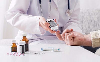 Illustrative image of a diabetes patient measuring blood sugar levels (Maya23K, iStock by Getty Images)