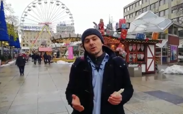David Rogovoy, the World Bnei Akiva emissary to Germany, lights a menorah on outside the Berlin Christmas market where a truck deliberately drove into a crowd last year. (Screen capture: Facebook) David Rogovoy, the World Bnei Akiva emissary to Germany, lights a menorah on outside the Berlin Christmas market where a truck deliberately drove into a crowd last year. (Screen capture: Facebook)