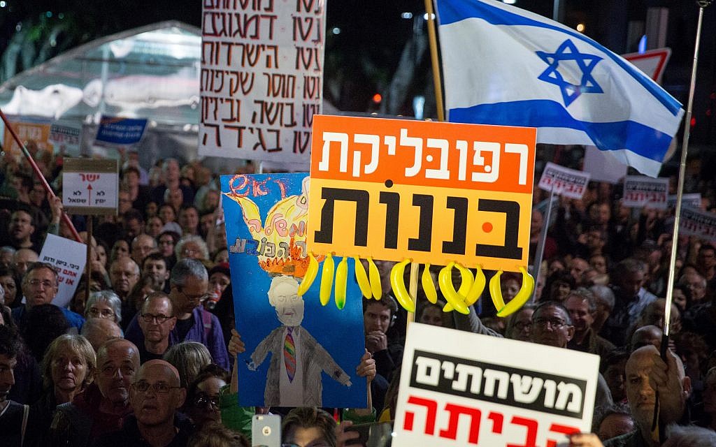 Israelis holding signs and shout slogans during a protest against the corruption of the government in Tel Aviv on December 16, 2017. (Miriam Alster/Flash90) Israelis holding signs and shout slogans during a protest against the corruption of the government in Tel Aviv on December 16, 2017. (Miriam Alster/Flash90)