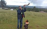 Yehudah Kimani blows a shofar on December 13, 2017, in his home of Kasuku in the highlands of Kenya. (courtesy Yehudah Kimani/Facebook)