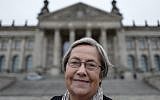 Karin Felix, who served as a guide at the Reichstag parliament building for a quarter-century, poses in front the Reichstag building in Berlin on November 23, 2017. (AFP/John MacDougall)