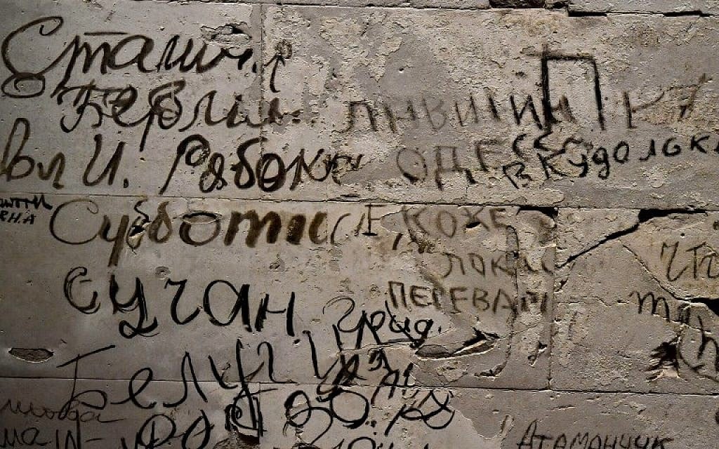 Picture taken on December 12, 2017 shows graffitis left over inside the Reichstag parliament building in Berlin. (AFP PHOTO / John MACDOUGALL)