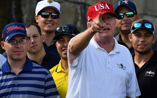 US President Donald Trump speaks to service members of the United States Coast Guard during an invitation to play golf at Trump International Golf Course in Mar-a-Lago, Florida on December 29, 2017. (AFP/Nicholas Kamm) US President Donald Trump speaks to service members of the United States Coast Guard during an invitation to play golf at Trump International Golf Course in Mar-a-Lago, Florida on December 29, 2017. (AFP/Nicholas Kamm)
