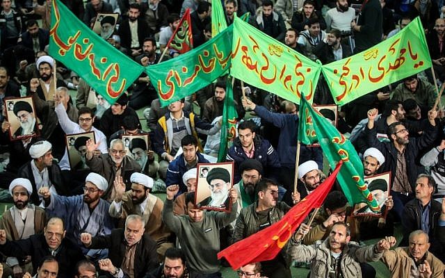 Iranians chant slogans as they march in support of the government near the Imam Khomeini grand mosque in the capital Tehran on December 30, 2017. (HAMED MALEKPOUR/TASNIM NEWS/AFP)
