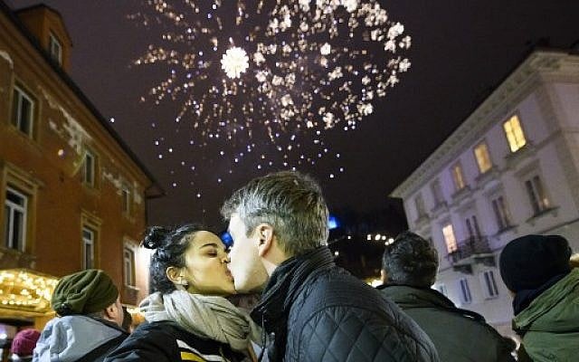 A couple kisses during New Year's celebrations just after midnight in Ljubljana, Slovenia on January 1, 2018. (AFP PHOTO / Jure Makovec) A couple kisses during New Year's celebrations just after midnight in Ljubljana, Slovenia on January 1, 2018. (AFP PHOTO / Jure Makovec)