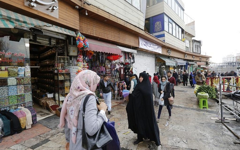 Illustrative: Iranians walk on a street in the capital Tehran on January 2, 2018. (AFP/ ATTA KENARE) Illustrative: Iranians walk on a street in the capital Tehran on January 2, 2018. (AFP/ ATTA KENARE)