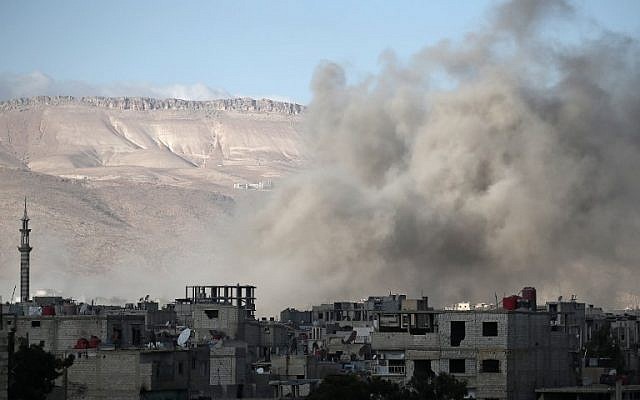 Smoke rises from buildings following an airstrike on the rebel-held besieged town of Arbin, in the eastern Ghouta region on the outskirts of the capital Damascus on January 2, 2018. (AFP / ABDULMONAM EASSA) Smoke rises from buildings following an airstrike on the rebel-held besieged town of Arbin, in the eastern Ghouta region on the outskirts of the capital Damascus on January 2, 2018. (AFP / ABDULMONAM EASSA)