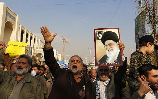 Pro-government demonstrators hold a poster of Iran's Supreme Leader, Ayatollah Ali Khamenei (R) and shout slogans of support during a march after the weekly Muslim Friday prayers in Tehran on January 5, 2018. (AFP Photo/Atta Kenare) Pro-government demonstrators hold a poster of Iran's Supreme Leader, Ayatollah Ali Khamenei (R) and shout slogans of support during a march after the weekly Muslim Friday prayers in Tehran on January 5, 2018. (AFP Photo/Atta Kenare)