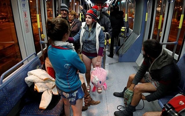 People taking part in the annual international "No Pants Subway Ride" day travel on the Jerusalem light train on January 7, 2018. (AFP PHOTO / AHMAD GHARABLI) People taking part in the annual international "No Pants Subway Ride" day travel on the Jerusalem light train on January 7, 2018. (AFP PHOTO / AHMAD GHARABLI)