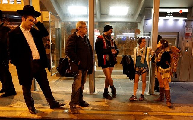 People taking part in the annual international "No Pants Subway Ride" day wait for the Jerusalem light train on January 7, 2018. (AFP PHOTO / AHMAD GHARABLI) People taking part in the annual international "No Pants Subway Ride" day wait for the Jerusalem light train on January 7, 2018. (AFP PHOTO / AHMAD GHARABLI)