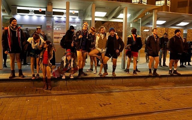 People taking part in the annual international "No Pants Subway Ride" day wait for the Jerusalem light train on January 7, 2018. (AFP PHOTO / AHMAD GHARABLI) People taking part in the annual international "No Pants Subway Ride" day wait for the Jerusalem light train on January 7, 2018. (AFP PHOTO / AHMAD GHARABLI)