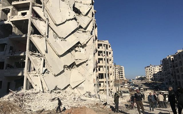 People look at the damage in the aftermath of an explosion in a rebel-held area of the northwestern Syrian city of Idlib on January 8, 2018. (AFP Photo/Omar Haj Kadour) People look at the damage in the aftermath of an explosion in a rebel-held area of the northwestern Syrian city of Idlib on January 8, 2018. (AFP Photo/Omar Haj Kadour)