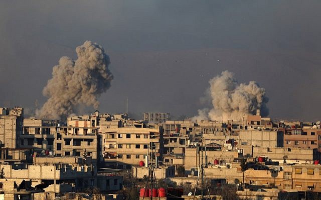 Smoke rises from buildings following air strikes on the rebel-held besieged town of Arbin, in the eastern Ghouta region on the outskirts of the capital Damascus on January 8, 2018. (AFP / Amer ALMOHIBANY) Smoke rises from buildings following air strikes on the rebel-held besieged town of Arbin, in the eastern Ghouta region on the outskirts of the capital Damascus on January 8, 2018. (AFP / Amer ALMOHIBANY)