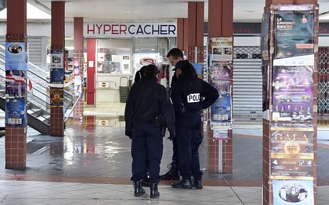 Illustrative: French police officers stand outside a Hyper Cacher supermarket adjacent to the Promo & Destock store, a French kosher grocery store in Creteil, south of Paris, that was destroyed in an arson attack on January 9, 2018. (AFP Photo/Alain Jocard) Illustrative: French police officers stand outside a Hyper Cacher supermarket adjacent to the Promo & Destock store, a French kosher grocery store in Creteil, south of Paris, that was destroyed in an arson attack on January 9, 2018. (AFP Photo/Alain Jocard)