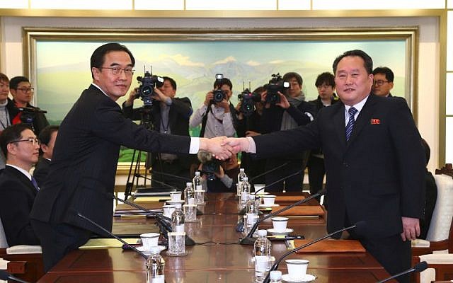 South Korea Unification Minister Cho Myung-Gyun (L) shaking hands with North Korean chief delegate Ri Son-Gwon (R) during their meeting at the border truce village of Panmunjom in the Demilitarized Zone (DMZ) dividing the two Koreas, January 9, 2018. (AFP Photo/Korea Pool) South Korea Unification Minister Cho Myung-Gyun (L) shaking hands with North Korean chief delegate Ri Son-Gwon (R) during their meeting at the border truce village of Panmunjom in the Demilitarized Zone (DMZ) dividing the two Koreas, January 9, 2018. (AFP Photo/Korea Pool)