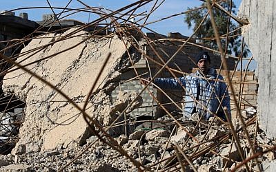 An Iraqi man, from the Shabak community, stands amidst the rubble of a house which was destroyed by Islamic State (IS) group jihadists in the village of Baz Gerkan east of Mosul on January 10, 2018. (AFP Photo/Ahman Al-Rubaye)