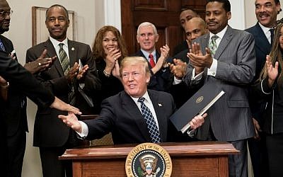 US President Donald Trump shakes hands after signing a proclamation during an event about Martin Luther King Jr. in the Roosevelt Room of the White House January 12, 2018 in Washington, DC. ( AFP PHOTO / Brendan Smialowski)