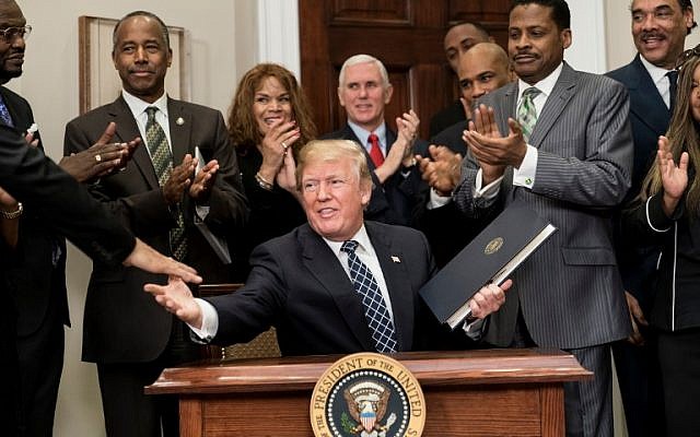 US President Donald Trump shakes hands after signing a proclamation during an event about Martin Luther King Jr. in the Roosevelt Room of the White House January 12, 2018 in Washington, DC. ( AFP PHOTO / Brendan Smialowski) US President Donald Trump shakes hands after signing a proclamation during an event about Martin Luther King Jr. in the Roosevelt Room of the White House January 12, 2018 in Washington, DC. ( AFP PHOTO / Brendan Smialowski)