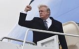 US President Donald Trump gestures as he boards Airforce One at Joint Base Andrews, Maryland, on January 12, 2018, for a weekend trip to Mar-a-Lago.  (AFP PHOTO / Nicholas Kamm)