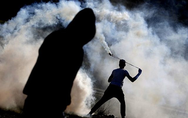 Palestinians clash with Israeli forces at a rally in support of members of the Tamimi family in the West Bank village of Nabi Saleh on January 13, 2018. (AFP/Abbas Momani) Palestinians clash with Israeli forces at a rally in support of members of the Tamimi family in the West Bank village of Nabi Saleh on January 13, 2018. (AFP/Abbas Momani)