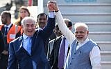 Indian Prime Minister Narendra Modi, right, and Prime Minister  Benjamin Netanyahu pose for photographers after the Israeli leader arrived at the Air Force Station in New Delhi January 14, 2018. (Prakash Singh/AFP)