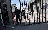 A Palestinian security man closes the gate of the Kerem Shalom crossing, the main passage point for goods entering Gaza, after it was closed by Israel following the discovery of smuggling tunnels underneath the crossing, in the southern Gaza Strip town of Rafah on January 14, 2018. (AFP PHOTO / SAID KHATIB)