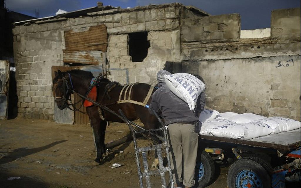 A Palestinian man loads a horse-pulled cart with food aid outside the United Nations food distribution center in Gaza City on January 15, 2018. (AFP Photo/Mohammed Abed) A Palestinian man loads a horse-pulled cart with food aid outside the United Nations food distribution center in Gaza City on January 15, 2018. (AFP Photo/Mohammed Abed)