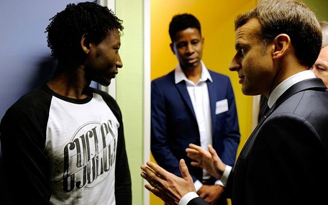 French President Emmanuel Macron speaks to Ahmed Adam (L) from Sudan during his visit to a migrant center in Croisilles, northern France, on January 16, 2018. (Michel Spingler/AFP) French President Emmanuel Macron speaks to Ahmed Adam (L) from Sudan during his visit to a migrant center in Croisilles, northern France, on January 16, 2018. (Michel Spingler/AFP)