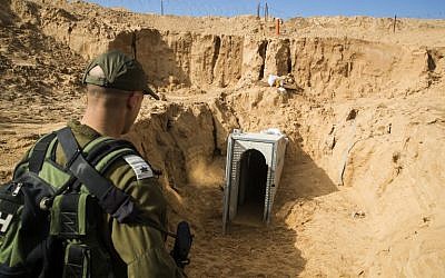An Israeli army officer looks at a destroyed Palestinian Islamic Jihad tunnel, leading from Gaza into Israel, near the southern Israeli kibbutz of Kissufim, January 2018. (Jack Guez/AFP/POOL)