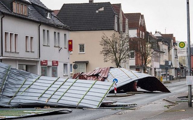 Metal roofing sheets from a supermarket blocking a road in Menden, western Germany, as the region is hit by the storm named 'Friederike,' January 18, 2018. (AFP Photo/dpa/Markus Kluemper/Germany OUT) Metal roofing sheets from a supermarket blocking a road in Menden, western Germany, as the region is hit by the storm named 'Friederike,' January 18, 2018. (AFP Photo/dpa/Markus Kluemper/Germany OUT)