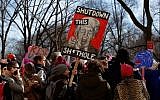 A woman holds a sign during thel Women's March in Chicago on January 20, 2018. (AFP Photo/Jim Young)