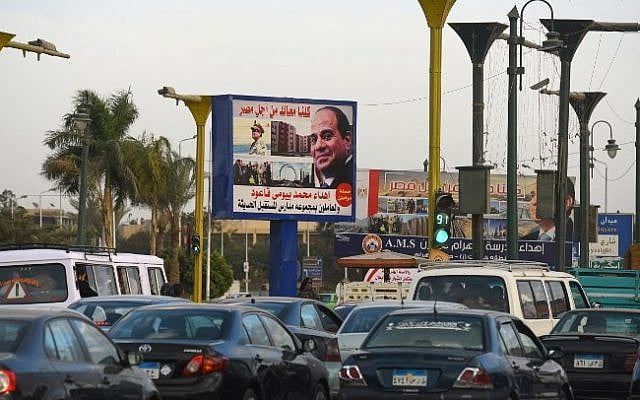 Egyptians drive past a billboard bearing the image of Egyptian President Abdel-Fattah el-Sissi, as part of the campaign for his reelection in the upcoming polls scheduled for March 2018, on January 22, 2018, in Cairo. (AFP PHOTO / MOHAMED EL-SHAHED) Egyptians drive past a billboard bearing the image of Egyptian President Abdel-Fattah el-Sissi, as part of the campaign for his reelection in the upcoming polls scheduled for March 2018, on January 22, 2018, in Cairo. (AFP PHOTO / MOHAMED EL-SHAHED)