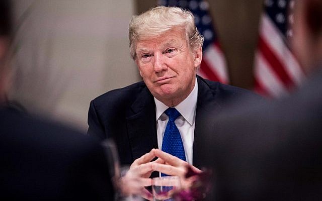 US President Donald Trump listens to a speaker during a working dinner with European business leaders during the World Economic Forum (WEF) annual meeting in Davos, eastern Switzerland, on January 25, 2018. (AFP PHOTO / NICHOLAS KAMM)