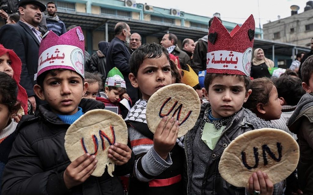 Palestinian children hold bread patties during a protest against aid cuts, outside the United Nations' offices in Khan Yunis in the southern Gaza Strip on January 28, 2018. (Said Khatib/AFP) Palestinian children hold bread patties during a protest against aid cuts, outside the United Nations' offices in Khan Yunis in the southern Gaza Strip on January 28, 2018. (Said Khatib/AFP)