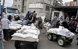 Palestinians collect aid parcels at a United Nations food distribution center in Khan Yunis in the southern Gaza Strip, January 28, 2018. (Said Khatib/AFP)