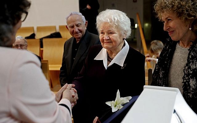 Alicja Mularska, the daughter of the late Polish couple Jan Dziadosz and Sabina Perzyna receives a medal and certificate of the Righteous Among the Nations award during a posthumous ceremony honouring her parents and their son Aleksandr Dziadosz at the Yad Vashem Museum on January 30, 2018. (AFP PHOTO / THOMAS COEX) Alicja Mularska, the daughter of the late Polish couple Jan Dziadosz and Sabina Perzyna receives a medal and certificate of the Righteous Among the Nations award during a posthumous ceremony honouring her parents and their son Aleksandr Dziadosz at the Yad Vashem Museum on January 30, 2018. (AFP PHOTO / THOMAS COEX)