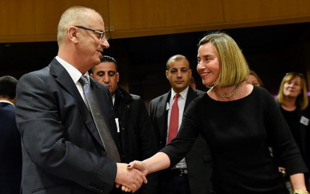 High Representative of the Union for Foreign Affairs and Security Policy Federica Mogherini (R) welcomes Palestinian Authority Prime Minister Rami Hamdallah (L) prior to an extraordinary international Palestine donors meeting at the EU headquarters in Brussels on January 31, 2018.  ( AFP PHOTO / JOHN THYS)
