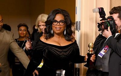 Oprah Winfrey arrives with the Cecil B. DeMille Award in the press room during The 75th Annual Golden Globe Awards at The Beverly Hilton Hotel on January 7, 2018 in Beverly Hills, California.  (Kevin Winter/Getty Images/AFP)