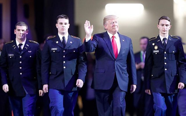 US President Donald Trump walks on the field during the national anthem prior to the CFP National Championship presented by AT&T between the Georgia Bulldogs and the Alabama Crimson Tide at Mercedes-Benz Stadium on January 8, 2018 in Atlanta, Georgia. (Jamie Squire/Getty Images/AFP) US President Donald Trump walks on the field during the national anthem prior to the CFP National Championship presented by AT&T between the Georgia Bulldogs and the Alabama Crimson Tide at Mercedes-Benz Stadium on January 8, 2018 in Atlanta, Georgia. (Jamie Squire/Getty Images/AFP)