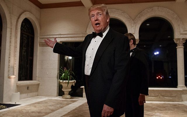 US President Donald Trump speaks with reporters as he arrives for a New Year's Eve gala at his Mar-a-Lago resort, December 31, 2017, in Palm Beach, Fla. (Evan Vucci/AP) US President Donald Trump speaks with reporters as he arrives for a New Year's Eve gala at his Mar-a-Lago resort, December 31, 2017, in Palm Beach, Fla. (Evan Vucci/AP)