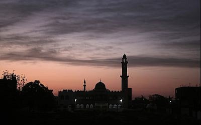 In this photo from January 3, 2018, the sun rises over a mosque in Gaza City. (AP Photo/Khalil Hamra)