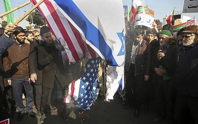 In this photo provided by Tasnim News Agency, Iranian demonstrators burn representations of US and Israeli flags in a pro-government rally in the northeastern city of Mashhad, Iran, Thursday, Jan. 4, 2018. (Nima Najafzadeh,Tasnim News Agency via AP) In this photo provided by Tasnim News Agency, Iranian demonstrators burn representations of US and Israeli flags in a pro-government rally in the northeastern city of Mashhad, Iran, Thursday, Jan. 4, 2018. (Nima Najafzadeh,Tasnim News Agency via AP)